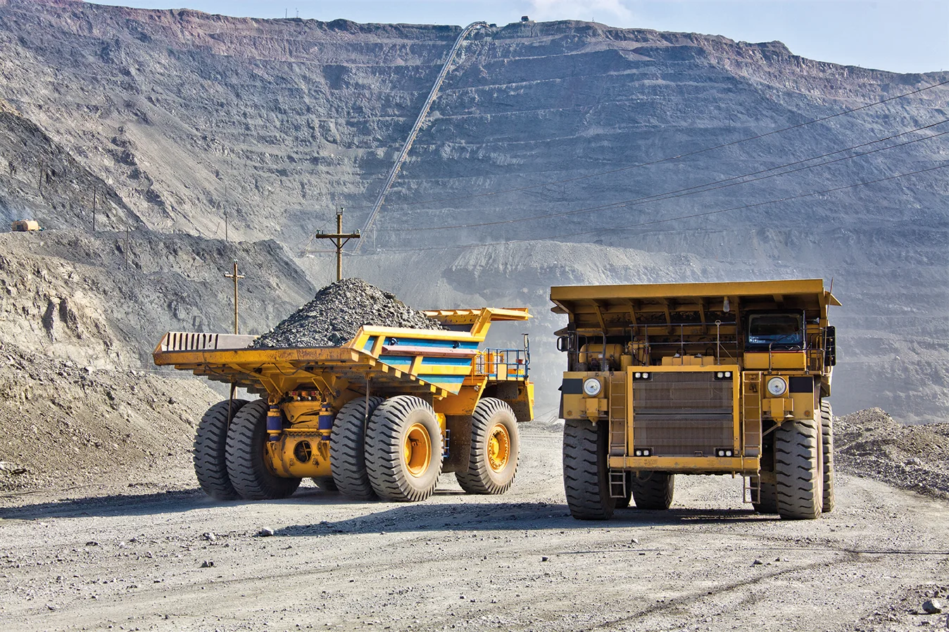Haul trucks operating in an open-pit mine.